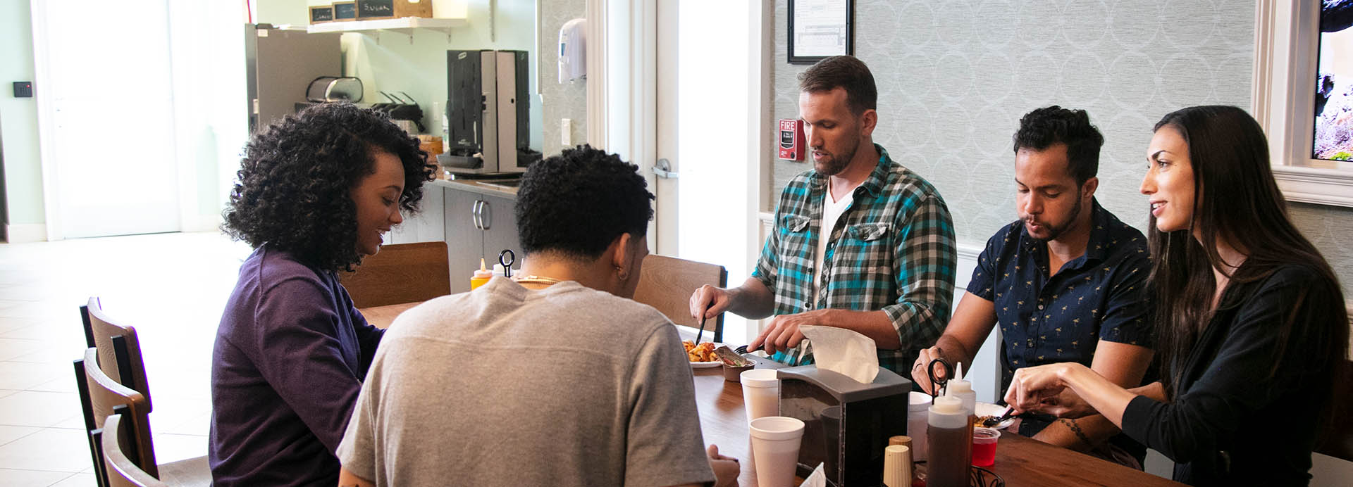 Patients chatting and having a meal at a cafeteria setting