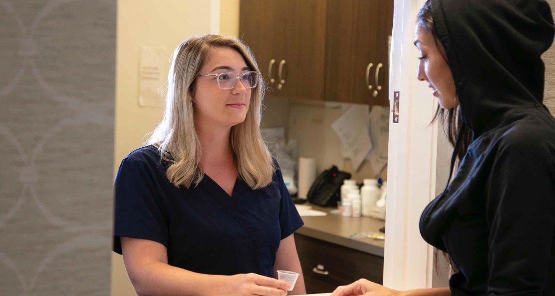 Two females engage in a intense conversation about the multiple drug and alcohol intervention methods, including the Johnson Model, Invitational Model, Systemic Family Model, ARISE Model, Motivational Interviewing, CRAFT, and the Field Model, showcasing their unique approaches to healing.