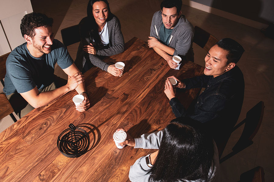 group of young adults chatting at the dining table after completing detoxification from heroin
